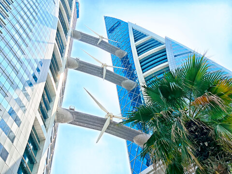 Modern architecture blends with palm trees in Manama, Bahrain on a bright day - Powered by Adobe