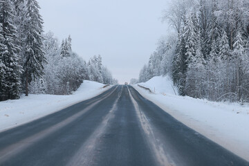 empty winter road, snow background in the surrounding landscape