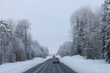 Obraz premium snowfall on a winter road, abstract background, blurred highway backdrop snowy landscape