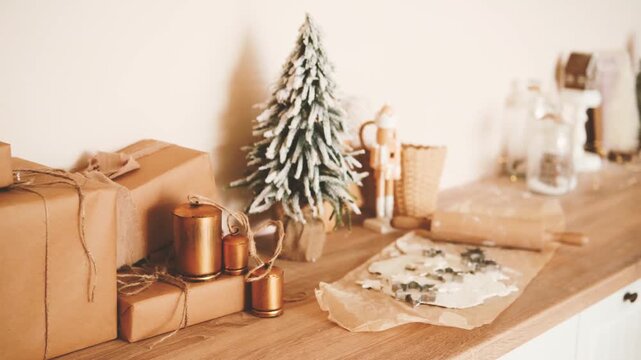 Christmas preparation with gifts tree nutcracker and cookie dough on wooden surface