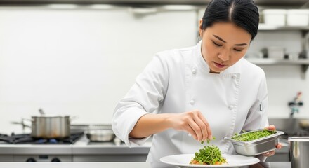 Asian woman chef plating food with fresh herbs in modern kitchen for International Women's Day