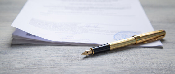 Pen and contract on the table.