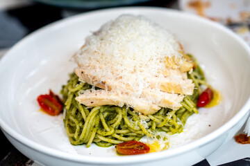 Delicious pesto chicken pasta italian restaurant gourmet dish urban setting close-up view culinary experience