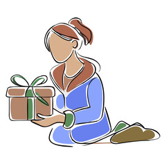 Woman kneeling while holding a gift box wrapped in green ribbon  