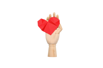 Wooden hand holds red origami heart for donation, isolated, PNG