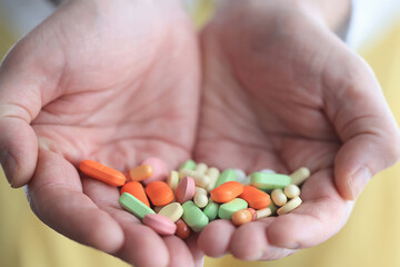 a lot of pills in the palm of a person's hand, medical background
