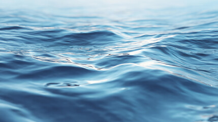 Naklejka premium Close-up of Gentle Blue Ocean Water Ripples and Waves with Soft Sunlight Reflections