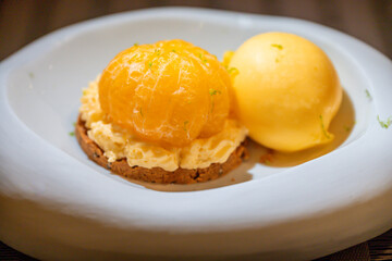 Close-up of Gourmet Orange Dessert with Biscuit and Sorbet. Fine Dining Cuisine.