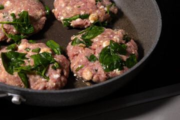 cooking raw turkey meatballs in a pan, healthy home meal