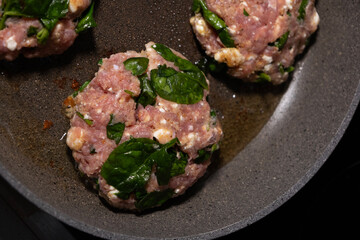 cooking raw turkey meatballs in a pan, healthy home meal
