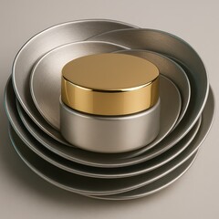 Round satin silver cream jar with polished golden lid nestled inside concentric brushed metal bowls, luxurious geometric cosmetic still life.
