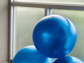 Stack of Yoga ball. Blue exercise ball in bright fitness, promoting wellness and healthy lifestyle.