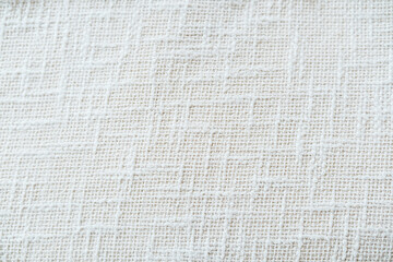 White woven fabric with textured grid pattern, close up detail, neutral background
