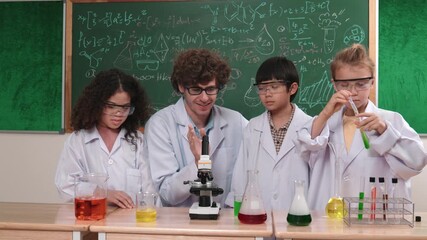 Skilled child hold tube while doing experiment while smart teacher explain and analyze chemical theory. Excited diverse student learning and enjoy exploring new innovation idea development. Pedagogy. - Powered by Adobe
