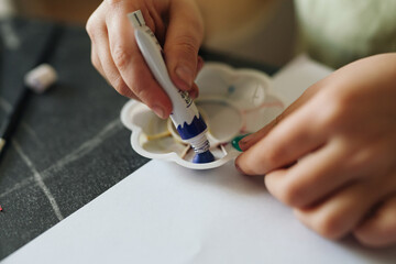 young artists create with colors, young children carefully use brushes and paints for artistic expression