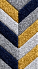 Close-up of a textured rug with a chevron pattern in yellow, navy blue, and grey stripes, creating a modern and geometric design.