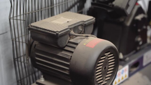 The engine of a running dusty motor near the compressor