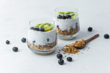 Healthy granola parfait with kiwi and blueberries in glass