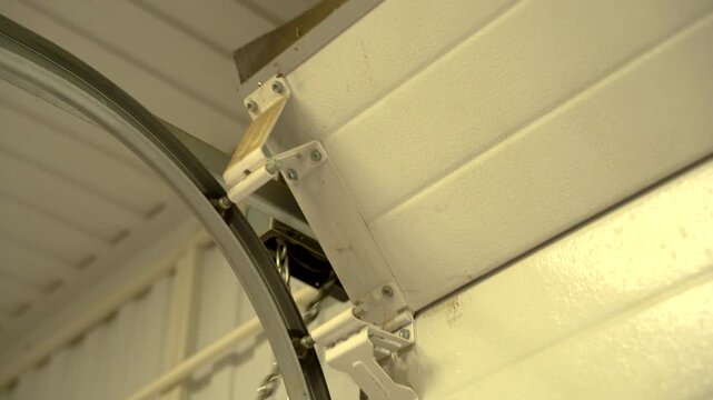 The roller shutters of the gate rise up along a chain