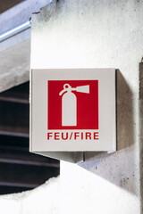 Montreal, Canada - August 15, 2025: Fire extinguisher sign on a concrete pillar in the parking area near the car rental zone