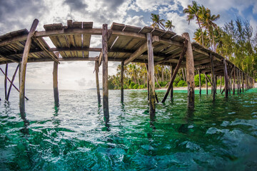 Wooden pier in quiet sea in Indonesia. Wide angle photo