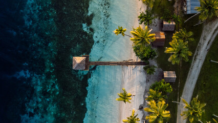Tropical beach with pier in ocean. Travel destination in Indonesia