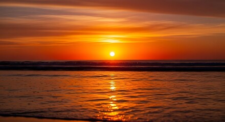 Obraz premium Vibrant orange sunset reflecting on ocean water peaceful evening scene