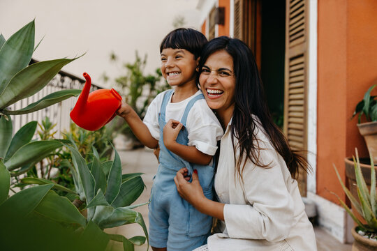 Mother and child enjoying gardening on a sunny day outdoors