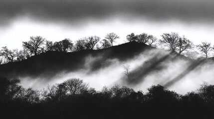 Atmospheric monochrome landscape with misty hills and bare trees, dramatically lit by sunbeams through clouds, evoking a serene and mysterious natural scene