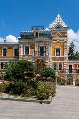 Dacha of Khlodov, founder of Riviera Park. Mansion features intricate patterns that combine classic elegance with whimsical design under bright blue sky. Sochi, Russia - June 30, 2025