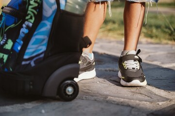 Child with Backpack and Sneakers on Stone Pathway