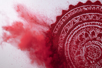 Decorative red powder mandala captured in a dynamic explosion of pigment. Vibrant, abstract composition with swirling particles and intricate circular patterns. Perfect for design and creative project