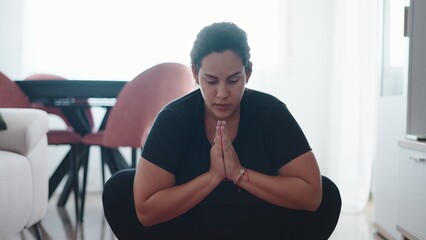 Pregnant woman meditating in yoga pose, practicing mindfulness and relaxation at home