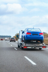 Automobile carrier driving on rural road