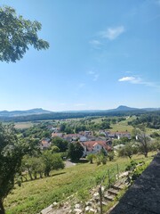 Beautiful view of the village Aach in the countyside of Germany on a sunny day with a blue sky and mountains in the distance