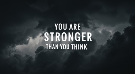 Motivational strength text over stormy clouds