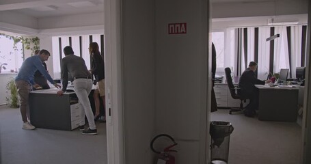 Business colleagues collaborate on a project in the office. They discuss ideas, review documents, and work together as a team. - Powered by Adobe