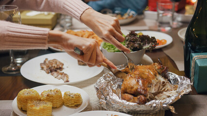 Group of Asia colleague gathering New year holidays party together. Close-up group of friends enjoy eat food over Christmas table thanksgiving dinner at home at night, celebrate and people concept.