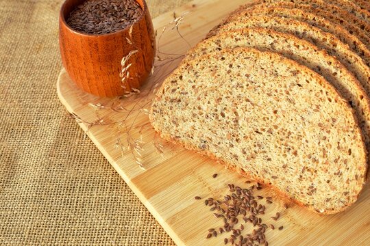 Freshly baked bread made from whole grain flour and flaxseed. Healthy eating concept. - Powered by Adobe