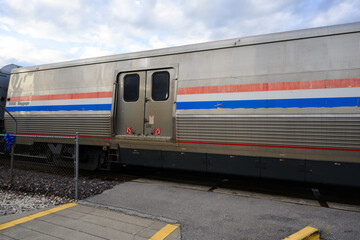 united states railroad train car at rail road crossing with red flashing lights