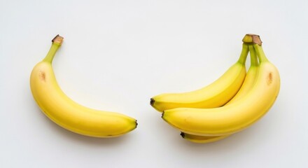 Fototapeta premium Yellow bananas on a plain white background, one separate, one in a bunch