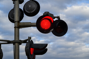 railroad crossing sign with red flashing light signal