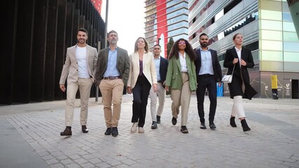 A determined group of businesspeople confidently walking together in stylish professional attire, showcasing teamwork and collaboration in a corporate setting, embodying success and partnership.