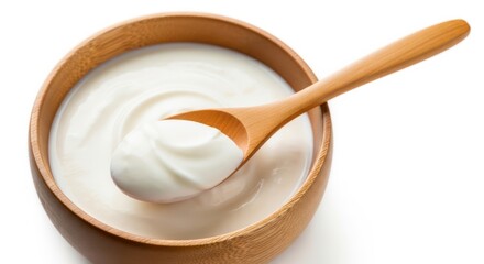 sour cream in wooden bowl and spoon, mayonnaise, yogurt, isolated on white background, full depth of field