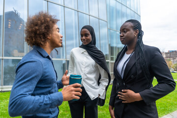 Diverse business professionals having informal conversation outdoors