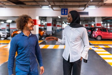 Diverse young couple talking enjoying urban conversation in parking