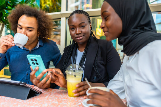 Diverse friends enjoying coffee and drinks at cafe