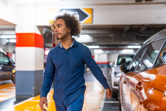 Young man walking through underground parking garage