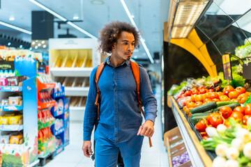Man choosing fresh produce in grocery store aisle