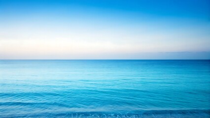 Vast ocean horizon under a gradient blue sky, serene water surface with gentle ripples and soft light.